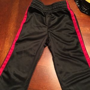 Black athletic pant with red stripe